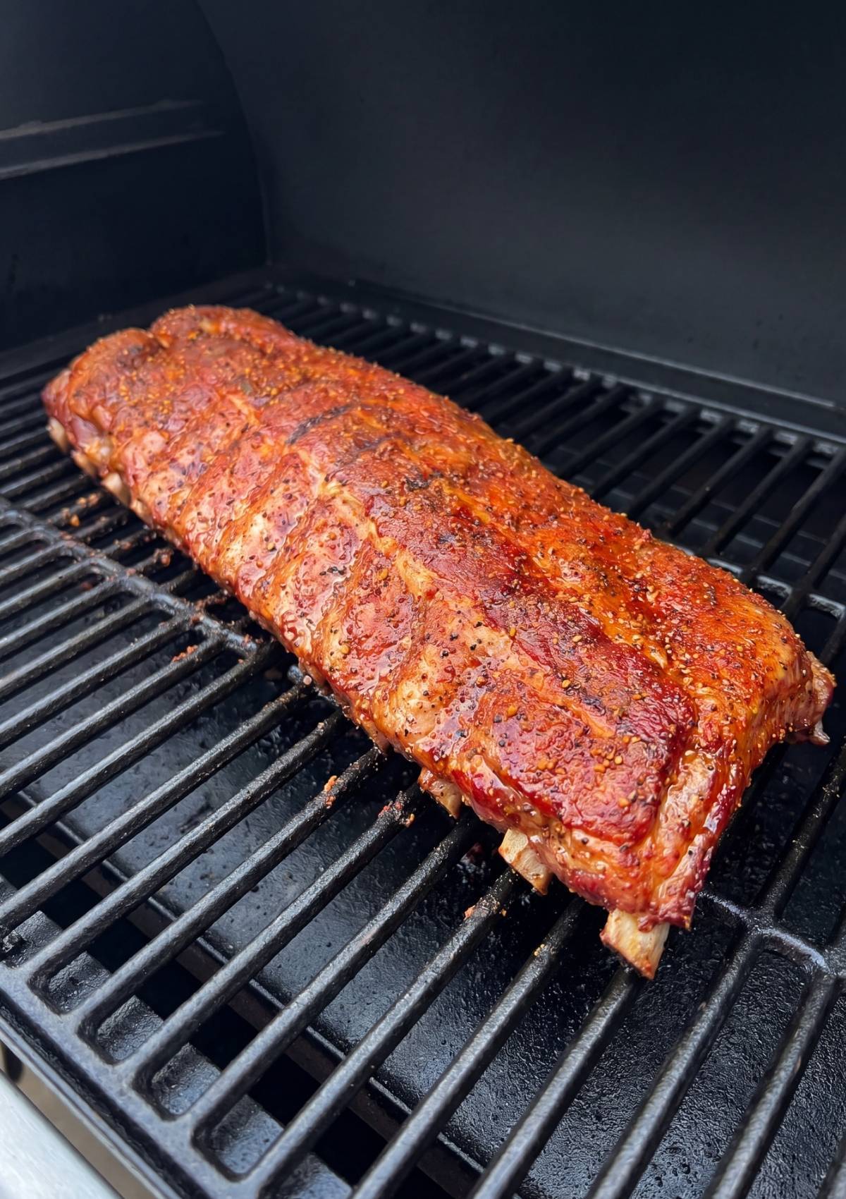 ribs cooking low and slow on pellet grill with seasoning best smoked ribs recipe pellet grill