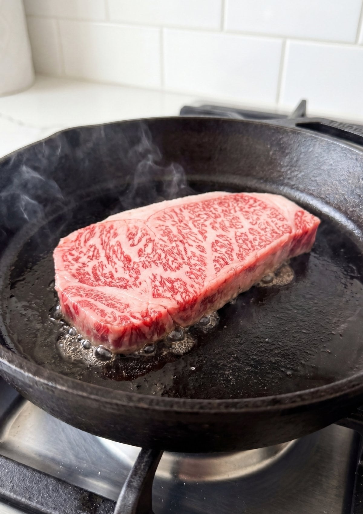 Japanese A5 wagyu beef recipe steak cooking in skillet with rich marbling melting for juicy tender results