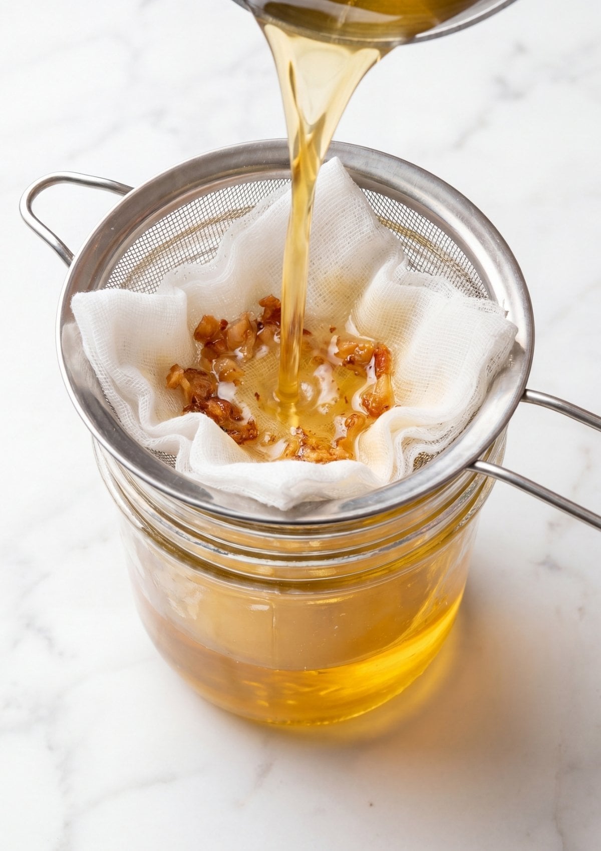 straining wagyu beef fat through cloth for wagyu beef tallow recipe clean homemade cooking oil