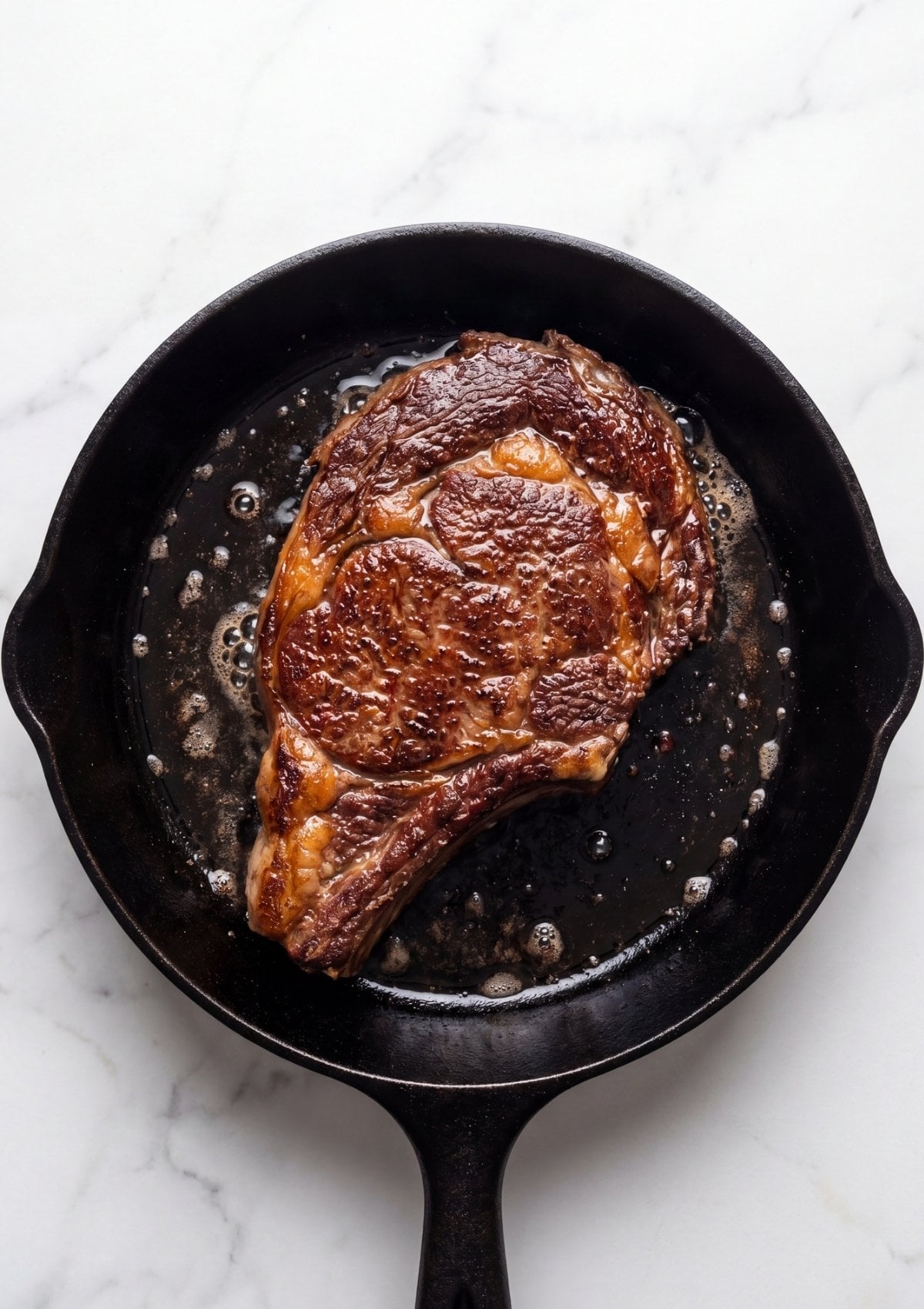 wagyu steak cooking in cast iron skillet with wagyu beef tallow recipe for perfect sear and high heat cooking