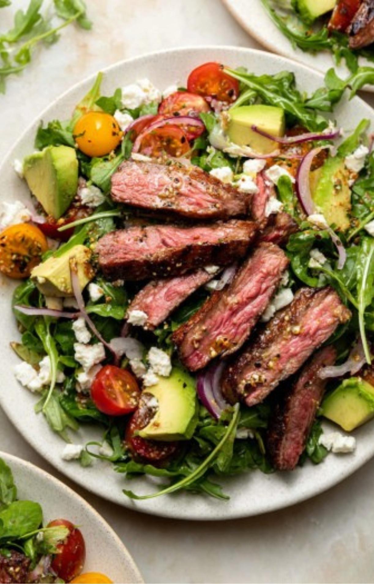 A fresh salad plate showcasing the perfect balance of protein and vegetables tossed in a tangy homemade vinaigrette.