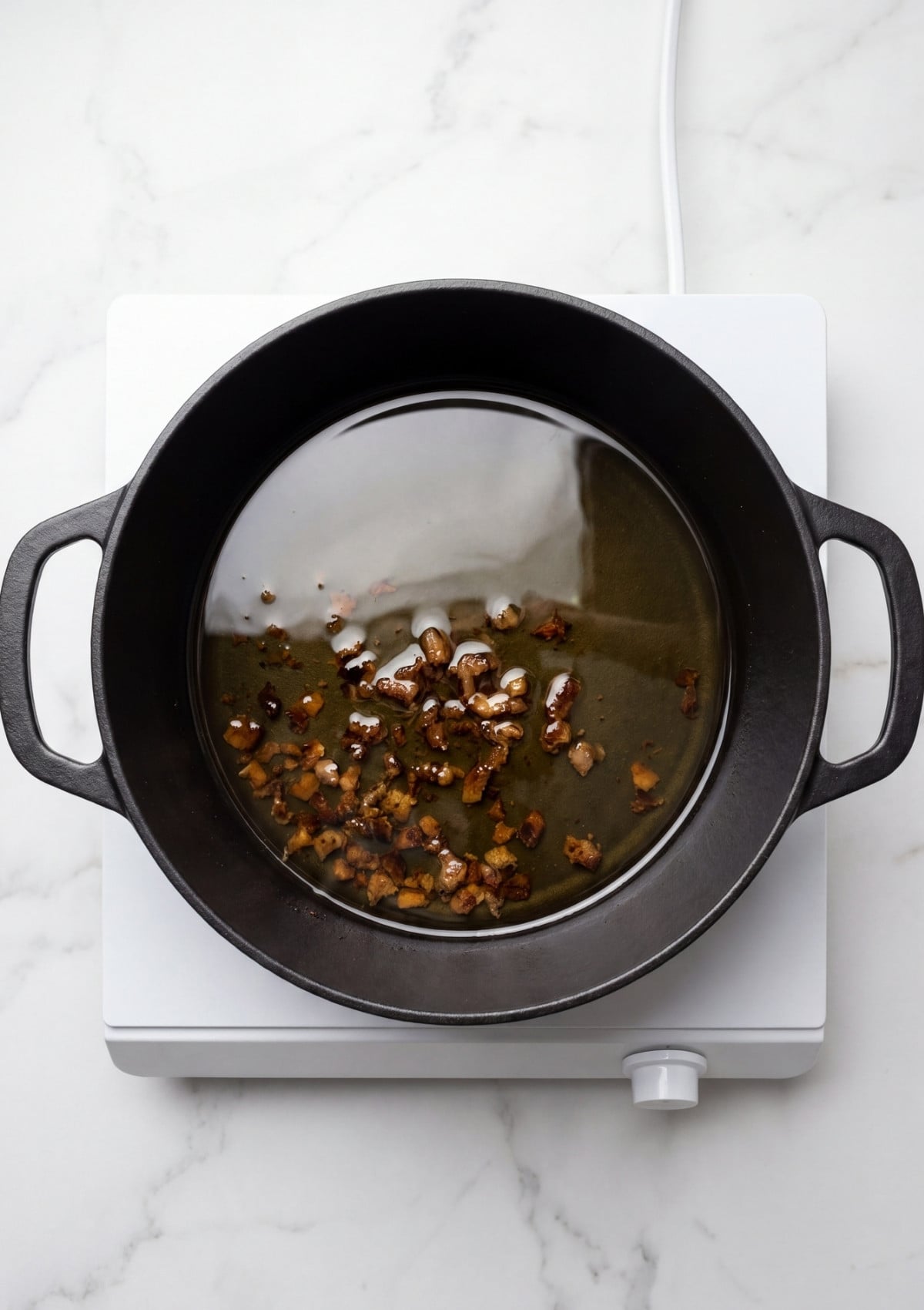 wagyu beef fat rendering in pot showing wagyu beef tallow recipe cooking process step