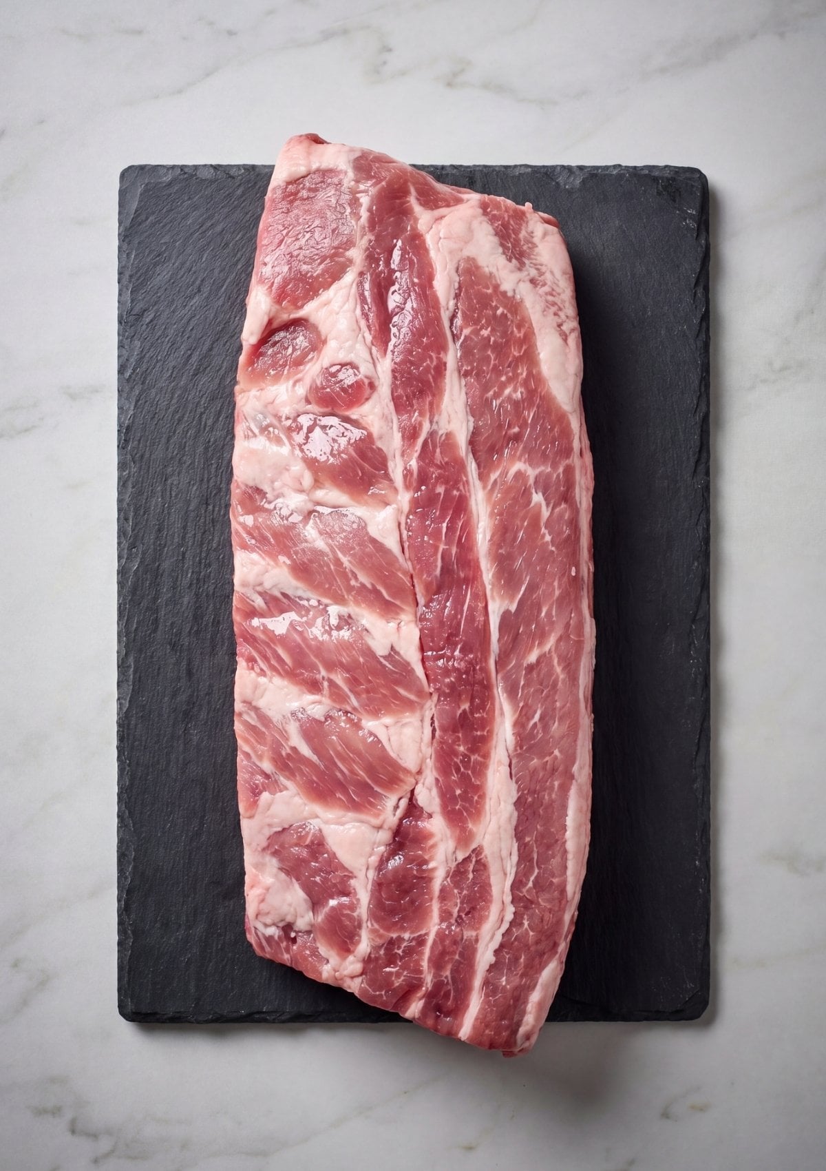 fresh raw pork spare ribs on board before seasoning for smoker recipe