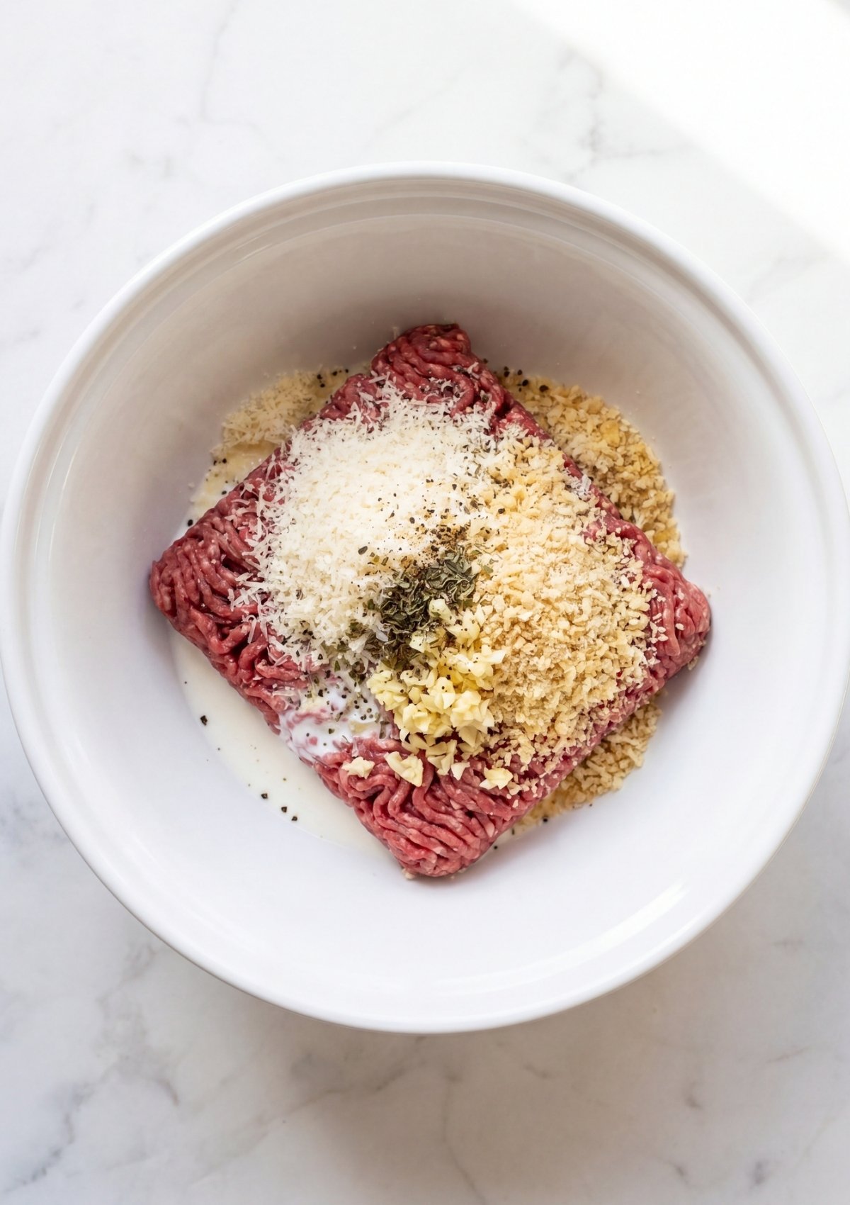 wagyu beef meatball mix with parmesan breadcrumbs garlic and seasoning ready to combine
