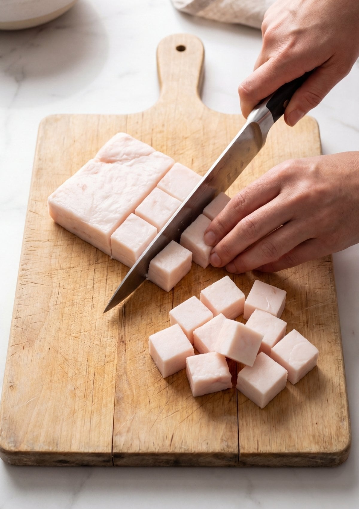 cutting wagyu beef fat into cubes for wagyu beef tallow recipe preparation step