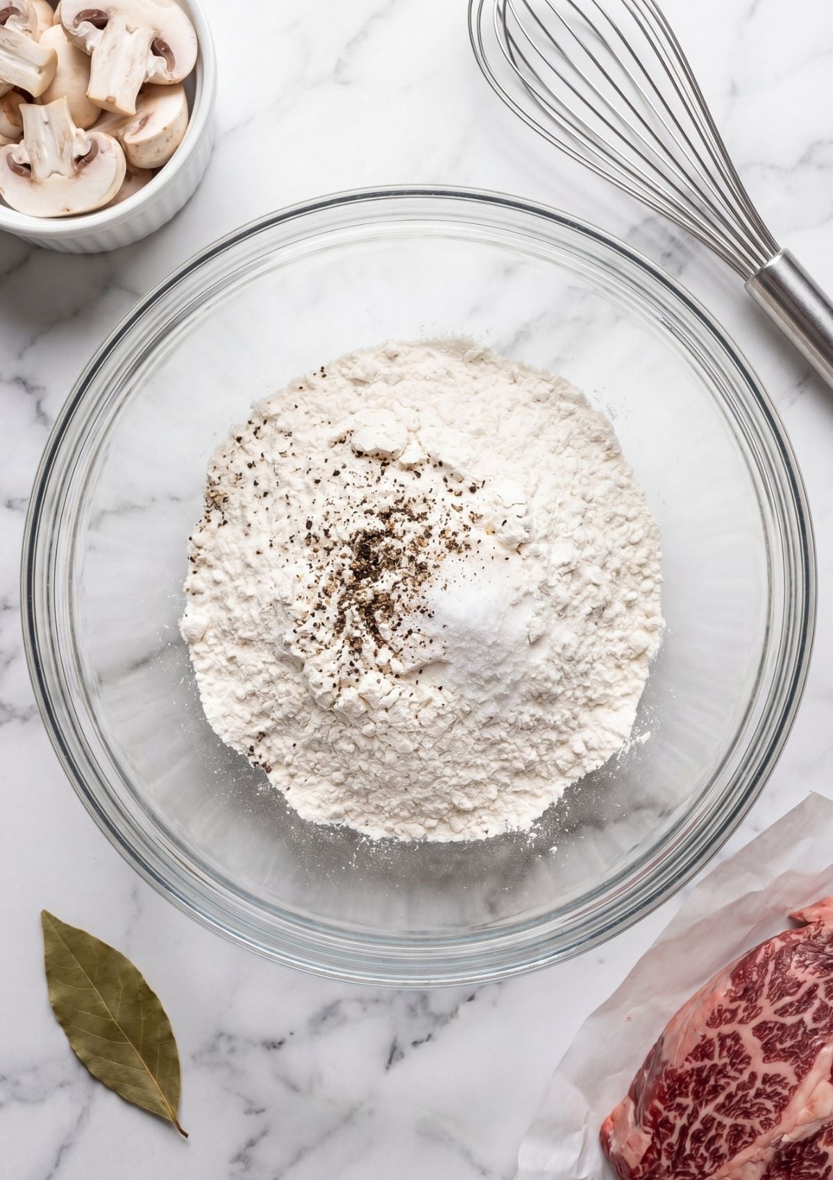 flour mixture for wagyu beef cheek recipe with seasoning in glass bowl