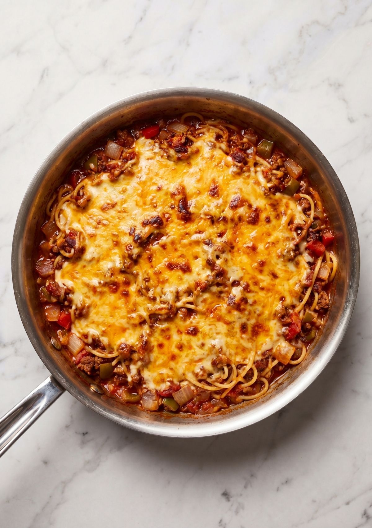 baked cowboy spaghetti with bacon topped with golden melted cheese in pan easy family dinner recipe