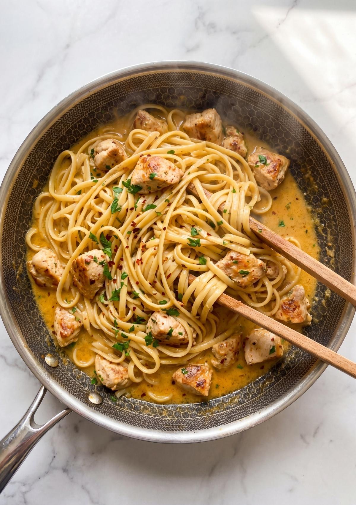 cowboy chicken spaghetti cooking in skillet with creamy sauce chicken and pasta easy one pot meal