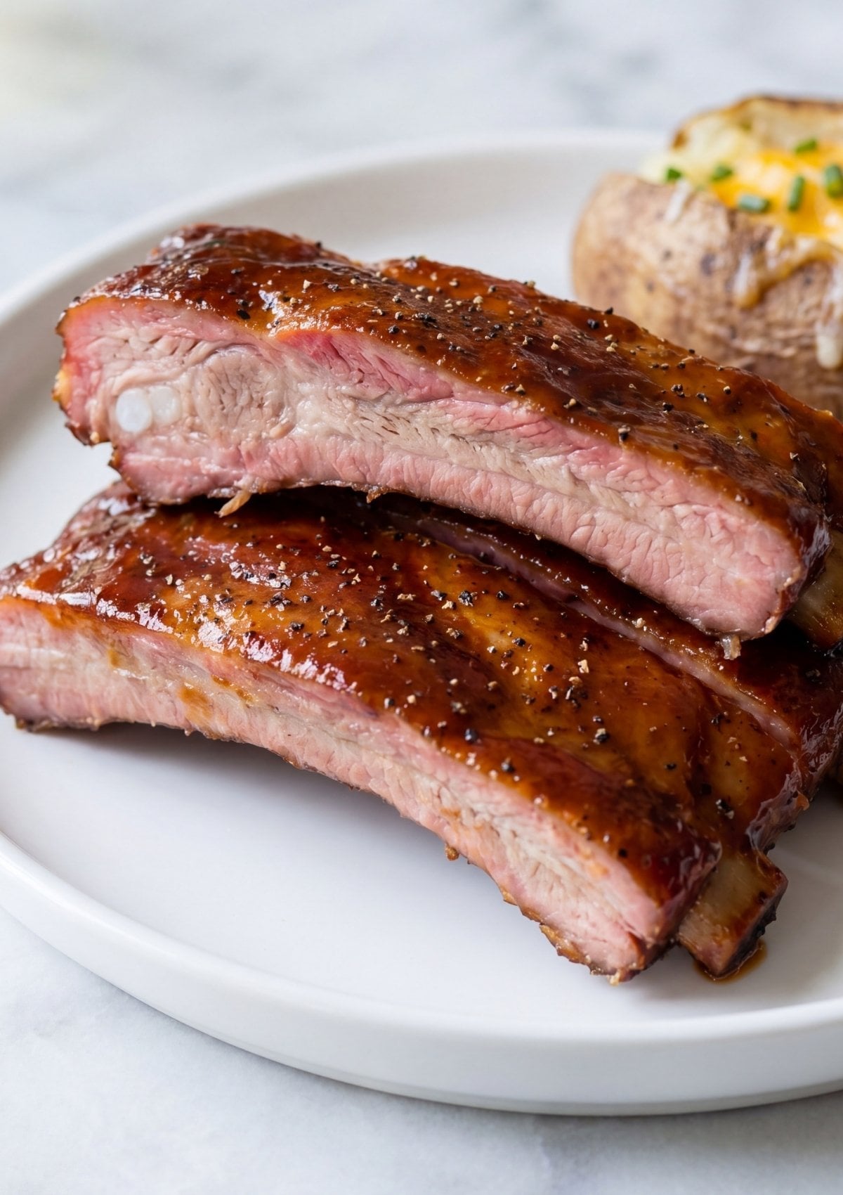 close up of juicy pellet smoker spare ribs recipe with glossy bbq glaze and tender meat