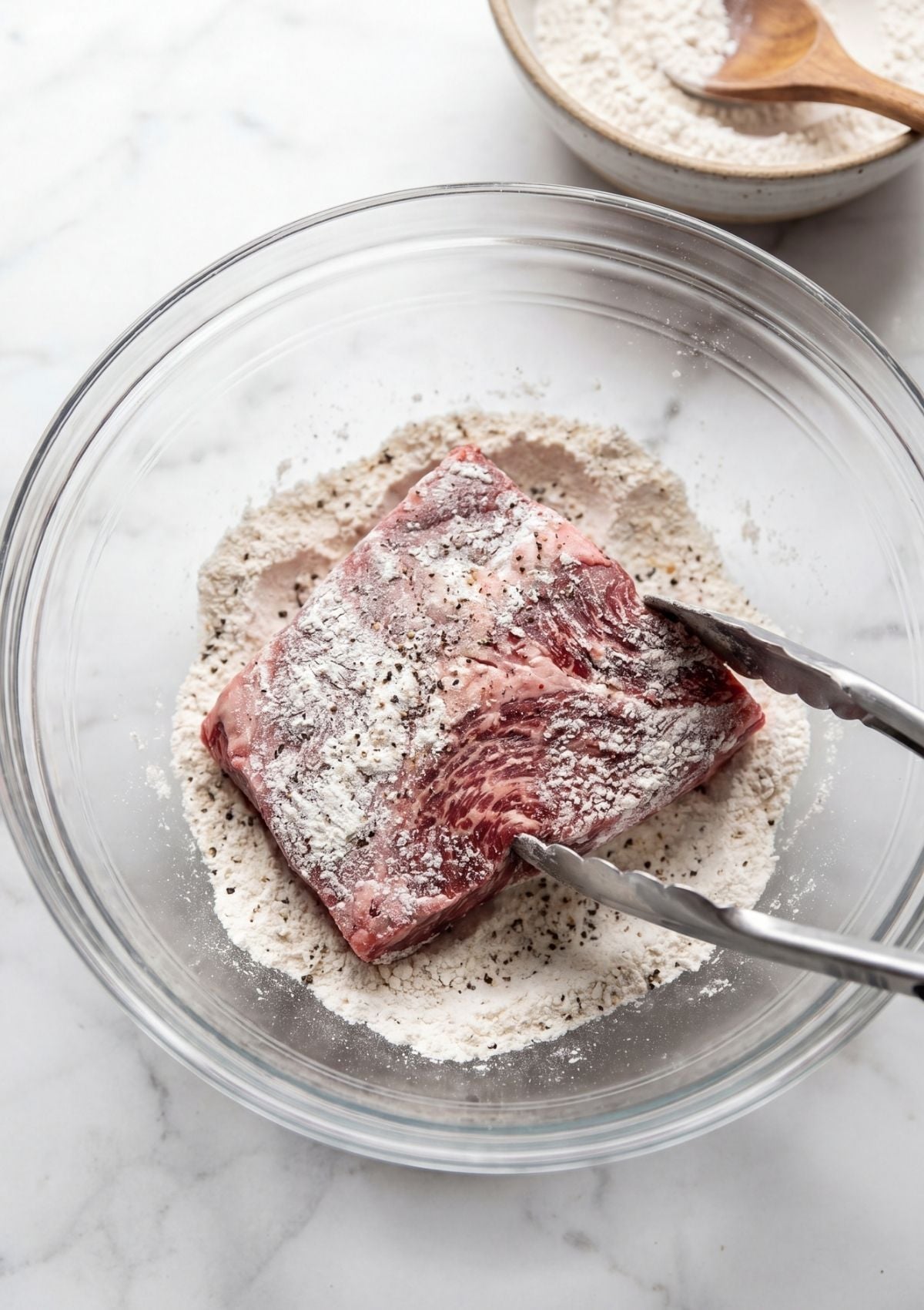 wagyu beef cheek coated in seasoned flour for wagyu beef cheek recipe preparation step