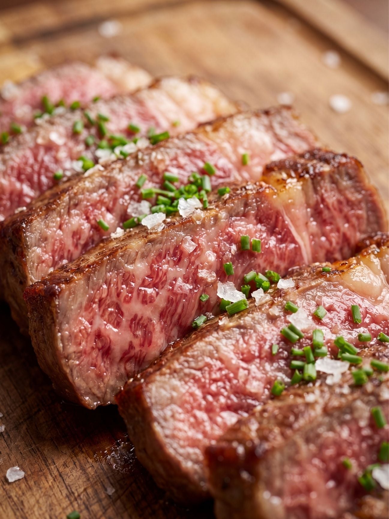 close up of wagyu beef marbling recipe showing juicy sliced steak with rich fat marbling and herbs