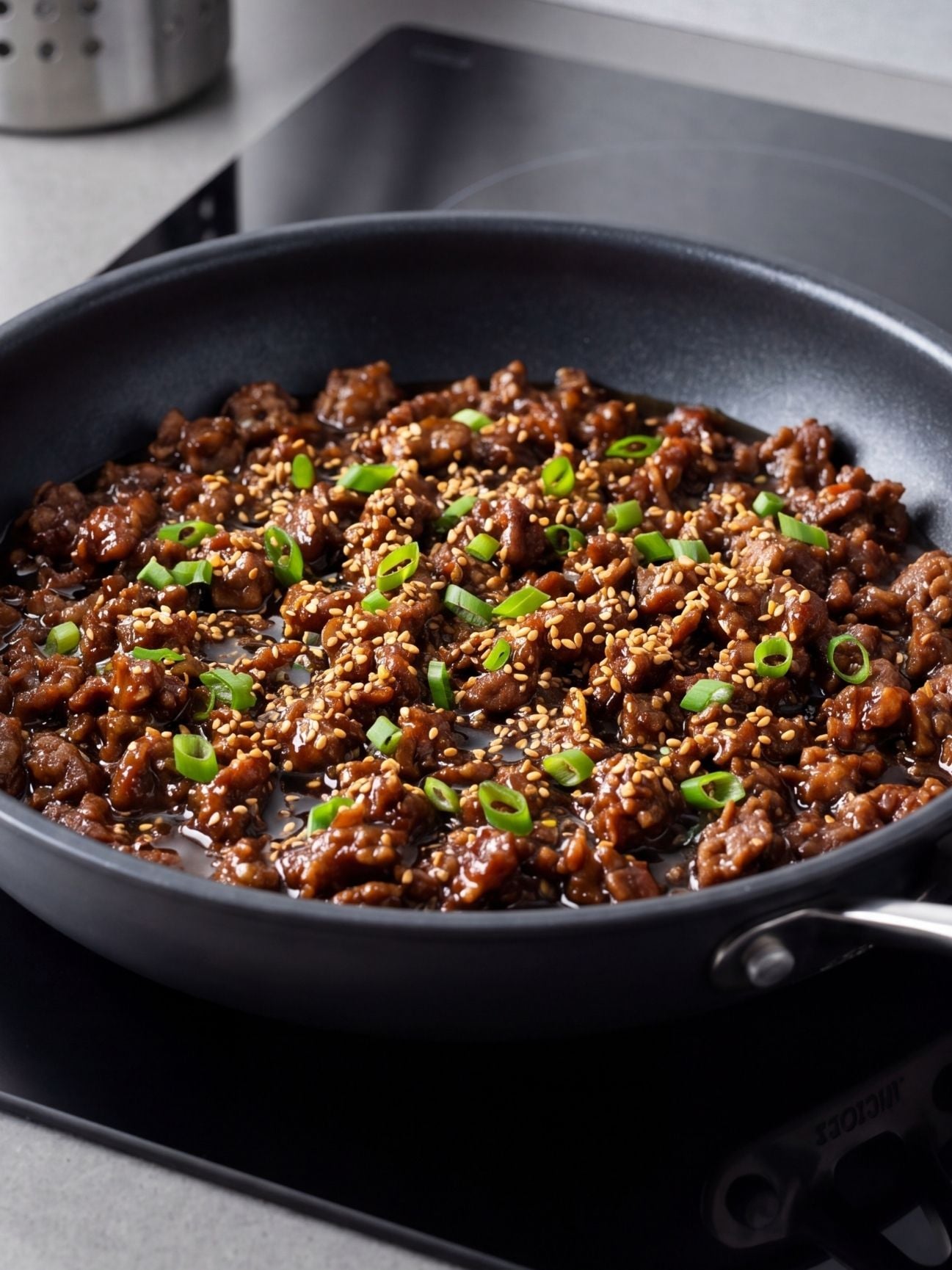 wagyu ground beef recipe close up of cooked beef with sauce sesame seeds and green onions