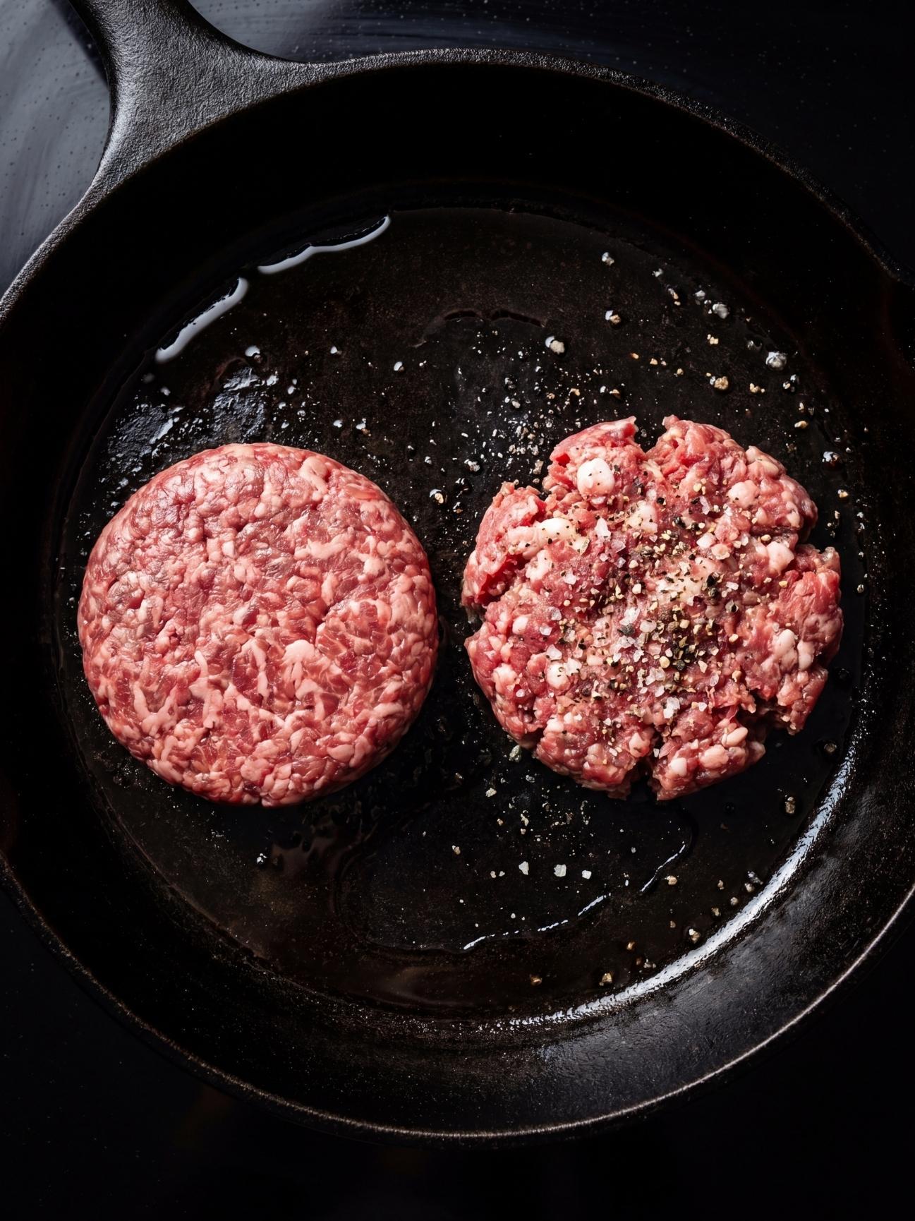 juicy wagyu beef burger patties recipe raw patties cooking in skillet with salt and pepper
