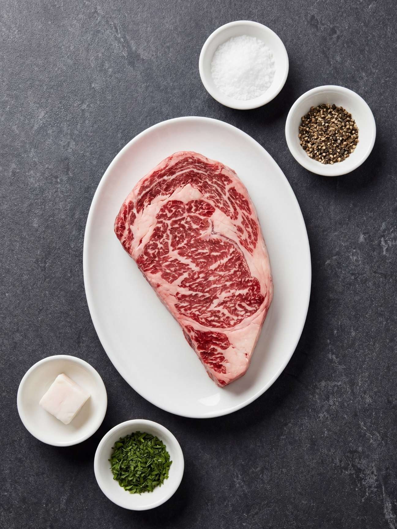 wagyu beef marbling recipe ingredients including raw wagyu steak salt pepper butter and herbs