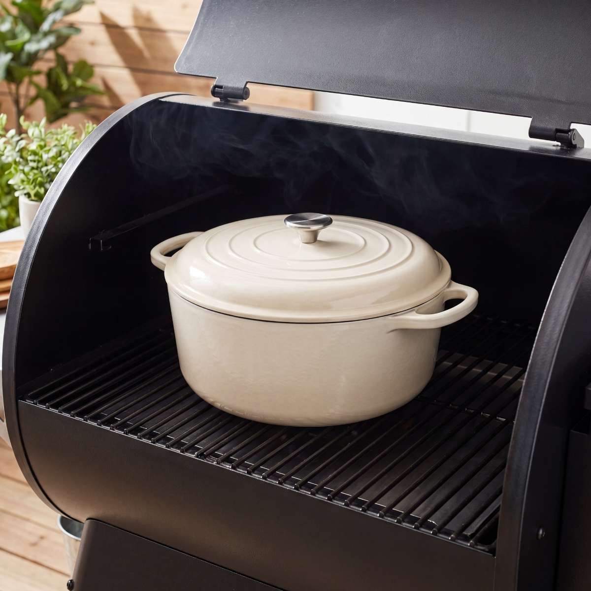 covered-white-dutch-oven-cooking-on-a-pellet-grill-smoker-with-the-lid-open