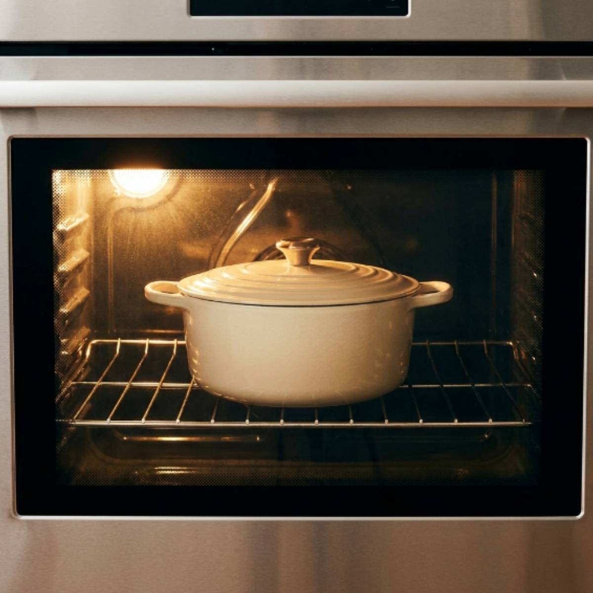 white-dutch-oven-with-lid-on-baking-on-the-rack-inside-a-home-oven