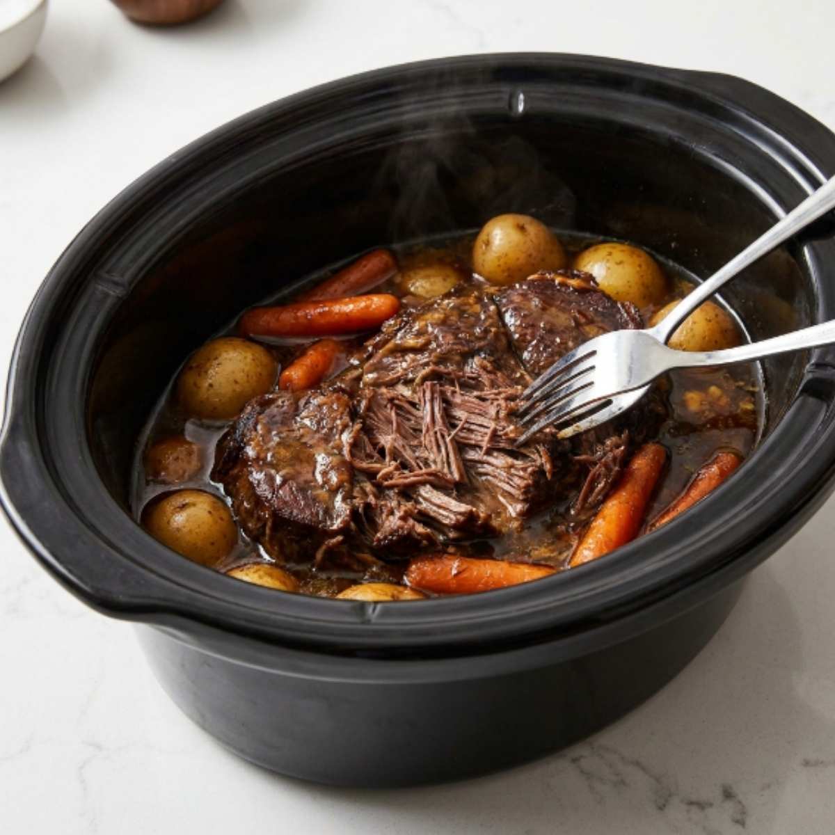mississippi-pot-roast-with-potatoes-and-carrots-cooking-under-a-glass-crockpot-lid