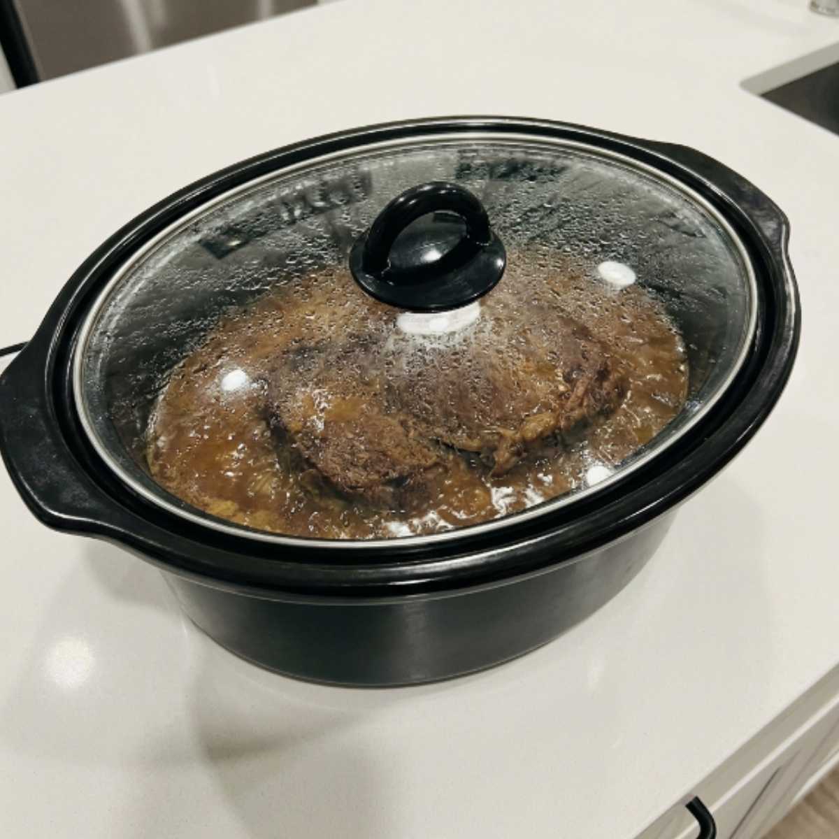 mississippi-pot-roast-braising-under-a-glass-slow-cooker-lid